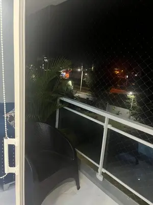 a black chair sitting on a balcony at night at Sol tropical in La Grúa