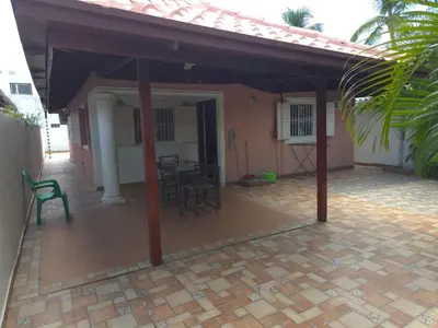 a patio with chairs and tables in a house at Apts dentro de Residencial Soficu Eden in La Laguna