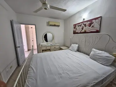 a bedroom with a white bed and a mirror at Apts dentro de Residencial Soficu Eden in La Laguna