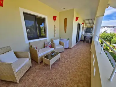 a living room with couches and chairs on a balcony at Apts dentro de Residencial Soficu Eden in La Laguna