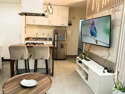 a kitchen with a tv hanging on a wall at Colonial leyton apartment in Santo Domingo