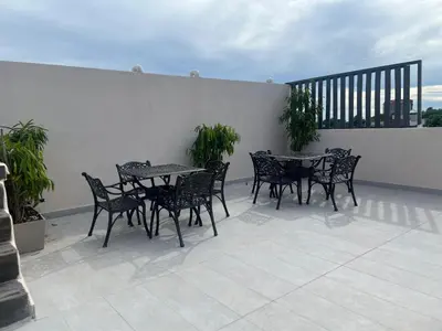 a group of tables and chairs on a patio at Colonial leyton apartment in Santo Domingo
