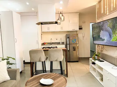 a kitchen with a table and two chairs in a room at Colonial leyton apartment in Santo Domingo