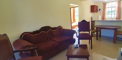 a living room with a couch and a table at Costambar Beachfront Pool Apartment in San Felipe de Puerto Plata