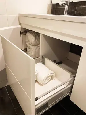 a white cabinet with a sink and towels at Luxury Santo Domingo Tower Condo in Santo Domingo