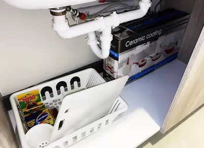 a laptop computer sitting under a sink with pipes at Luxury Santo Domingo Tower Condo in Santo Domingo