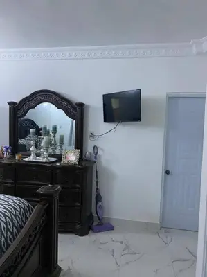a bedroom with a mirror and a dresser with a bed at Modern Country Side Lux Apt in La Ceibita