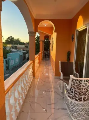 a balcony with chairs and a view of a pool at Modern Country Side Lux Apt in La Ceibita