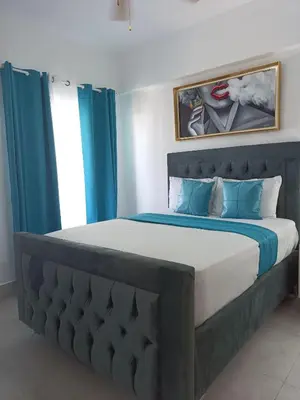 a bedroom with a large bed with blue curtains at Boca del Mar III, apartamento 707 in Cuevas