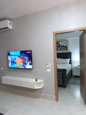 a room with a bed and a tv on a wall at Boca del Mar III, apartamento 707 in Cuevas