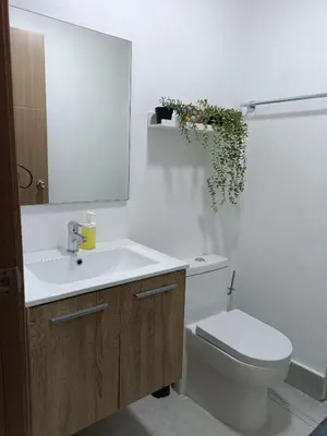 a bathroom with a sink and a toilet and a mirror at Boca del Mar III, apartamento 707 in Cuevas