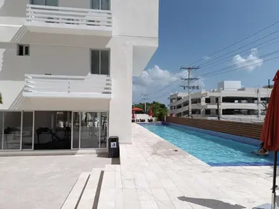 a building with a swimming pool next to a building at Boca del Mar III, apartamento 707 in Cuevas