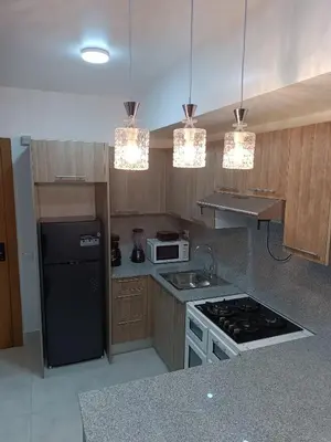 a kitchen with a black refrigerator and a stove top oven at Boca del Mar III, apartamento 707 in Cuevas