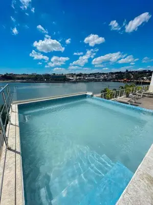 a large swimming pool with a view of the water at BEST Studio, Pool & Gym, River view from terrace in Calero
