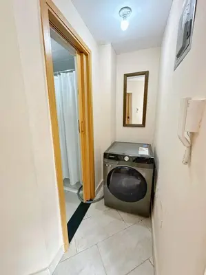 a bathroom with a washing machine in a room at BEST Studio, Pool & Gym, River view from terrace in Calero