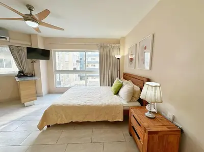 a bedroom with a bed and a ceiling fan at BEST Studio, Pool & Gym, River view from terrace in Calero