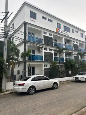 a white car parked in front of a building at Apartment, Close to the Bayahibe Beach in Bayahibe