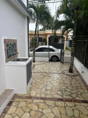 a stone courtyard with a car parked in a driveway at Apartment, Close to the Bayahibe Beach in Bayahibe