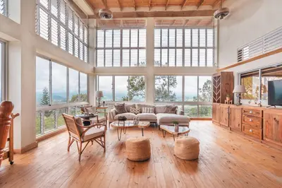 a living room with a large room with windows at Majestic villa with stunning views in Jarabacoa in Buena Vista
