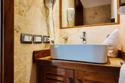 a bathroom with a sink and a mirror at Aligio Beachfront Resort & Spa in Las Terrenas