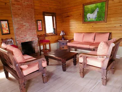 a living room with a couch and chairs and a fireplace at Villas Las Neblinas in Constanza