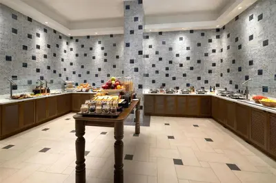 a buffet area with a table with food on it at Hotel Santiago, Curio Collection By Hilton in Santiago de los Caballeros