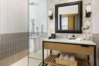 a bathroom with a sink and a mirror at Hotel Santiago, Curio Collection By Hilton in Santiago de los Caballeros