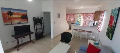 a living room with a piano and a dining room at Cabrera 6 in Cabrera