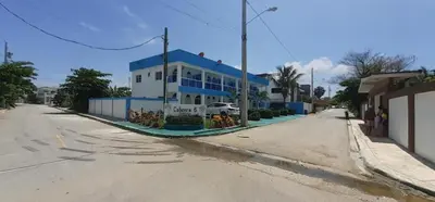 a blue and white building on the side of a street at Cabrera 6 in Cabrera