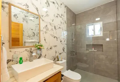 a bathroom with a sink and a toilet and a shower at Crown ll-3 Bedrooms-Pool-Close to everything! in San Felipe de Puerto Plata
