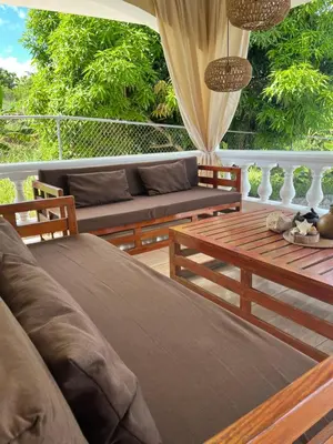a porch with a couch and a table at Villa Karolina in Las Galeras