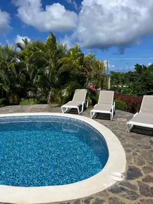 a swimming pool with two lounge chairs and a swimming pool at Villa Karolina in Las Galeras