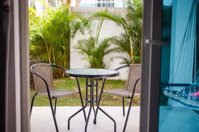 a table and two chairs on a porch with a patio at 104 PL - Elegante y moderno, posición perfecta in La Laguna
