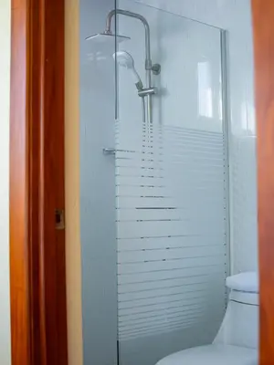 a glass shower in a bathroom with a toilet at Villas Vallejuelo in Vallejuelo