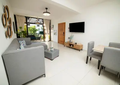 a living room with a couch and a table at Divine Stay 3 Bedroom One minute from the beach on the malecon in San Felipe de Puerto Plata