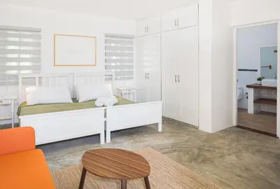 a bedroom with a bed and a table and a chair at KITE BEACH HOTEL Oceanfront Apartments in Cabarete
