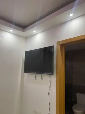 a flat screen tv on a wall in a room at Modern House in Santo Domingo Este in Juan López