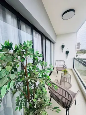 a balcony with two benches and a potted plant at Pool & Gym - 10min Aeropuerto y HOMS - Dream Stay in Santiago de los Caballeros