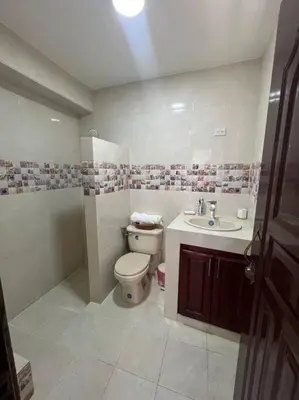 a bathroom with a toilet and a sink at Encantador y lujoso apartamento in San Pedro de Macorís