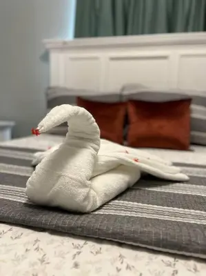 a swan made out of towels on a bed at Encantador y lujoso apartamento in San Pedro de Macorís