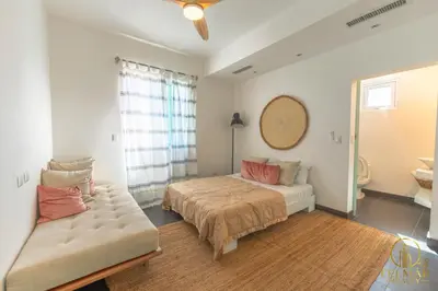 a bedroom with a bed and a couch at Brisas del norte in Sosúa