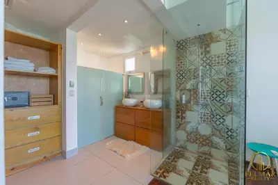 a bathroom with a shower with a glass door at Brisas del norte in Sosúa