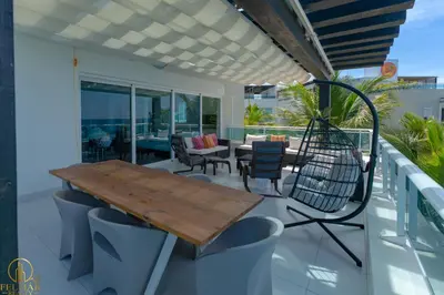 a patio with a wooden table and chairs on a balcony at Brisas del norte in Sosúa
