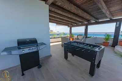 a kitchen with a stove and a grill and a barbecue at Brisas del norte in Sosúa
