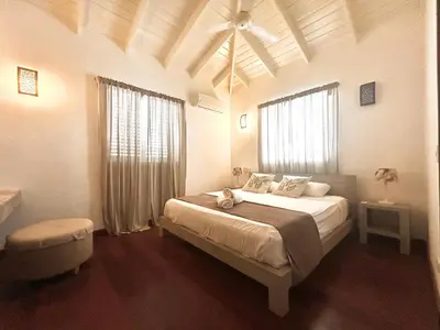 a bedroom with a large bed and a ceiling at Tropical Villa 4Bedroom 3Baths and Pool Near Beach in Las Terrenas