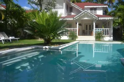 a house with a swimming pool in front of a house at Tropical Villa 4Bedroom 3Baths and Pool Near Beach in Las Terrenas