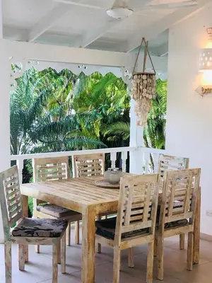 a dining room with a wooden table and chairs at Tropical Villa 4Bedroom 3Baths and Pool Near Beach in Las Terrenas