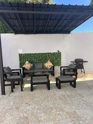 a group of tables and chairs under a roof at Crown lll with Pool -3 Bedrooms close to Everything in Puerto Plata