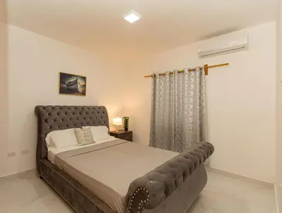 a bedroom with a bed in a room at Crown lll with Pool -3 Bedrooms close to Everything in Puerto Plata