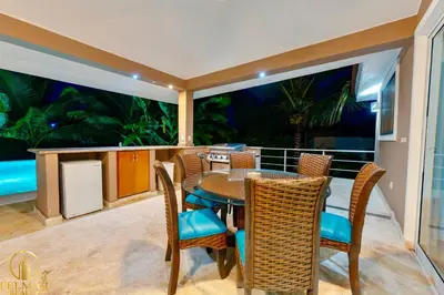 a balcony with a table and chairs with a view at Casa feliz in Sosúa